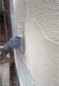 Applying silicone thin-coat render system and embedding mesh during our professional rendering course
